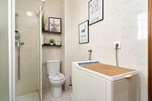 a white bathroom with a toilet and a shower at Apartamento Bellavista Torrox Park in Torrox +26 photos
