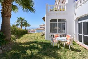 a patio with a table and chairs in front of a house at Apartamento Bellavista Torrox Park in Torrox