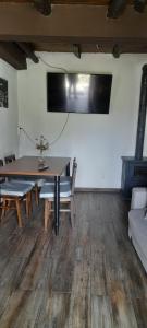 a living room with a table and a couch at Casa do Freire - Serra da Estrela in Aguincho +21 photos