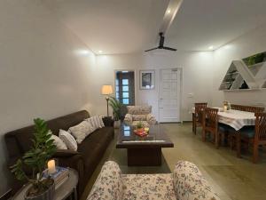a living room with a couch and a table at Red Brick House in Panchkula