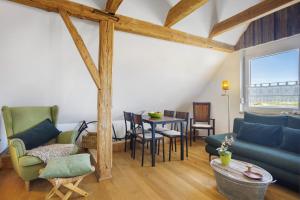a living room with a blue couch and a table at Beim Senner in Halblech
