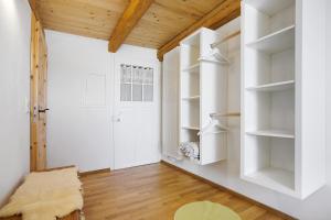 a room with white shelves and a door at Beim Senner in Halblech