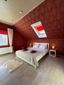 a bedroom with a bed and a red wall at Konrad Guesthouse in Kuressaare
