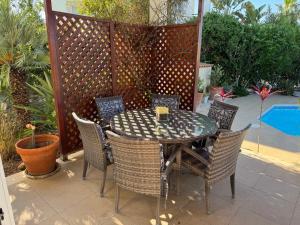 a table and chairs on a patio with a fence at Beach Villa Sofia in Neo Chorio +51 photos
