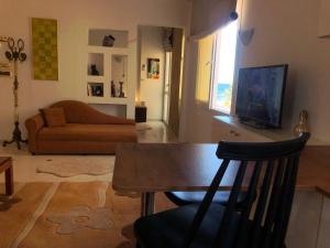 a living room with a table and a couch at Waterside in Hammam Sousse
