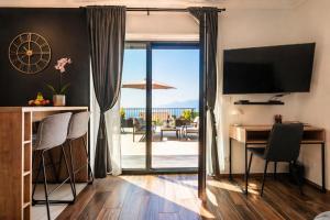 a room with a desk and a view of the ocean at Apartments Alba Chiara in Kastav