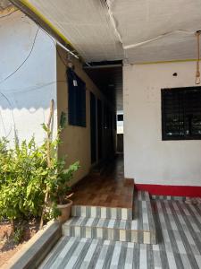 an outside view of a building with a porch at Chaitanya Beach Reesort in Dapoli