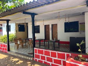 a patio with tables and chairs on a house at Chaitanya Beach Reesort in Dapoli +12 photos