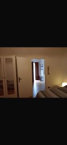 a bedroom with a bed and a mirror and a door at Casa dei lupi in Montefalco