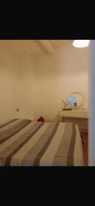a bedroom with a bed and a mirror at Casa dei lupi in Montefalco