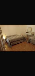 a bedroom with a bed and a mirror on the wall at Casa dei lupi in Montefalco