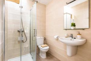 a bathroom with a toilet and a sink and a shower at Villa San Jose by Villa Plus in Cala en Porter +18 photos