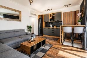a living room with a couch and a table at Apartments Alba Chiara in Kastav