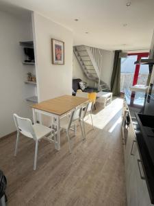 a kitchen and dining room with a table and chairs at Les 3 conserveries in Le Crotoy