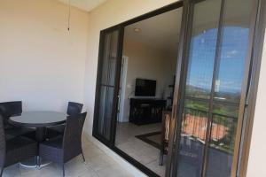 a room with a table and chairs and a balcony at Stunning Oceanview Condo with Exceptional Views & Resort-Style Amenities in Coco