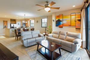 a living room with a couch and a table at Stunning Oceanview Condo with Exceptional Views & Resort-Style Amenities in Coco