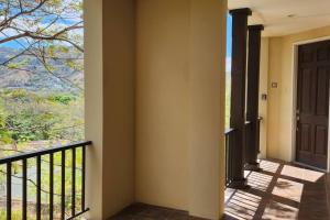 a room with a balcony with a door and a view at Stunning Oceanview Condo with Exceptional Views & Resort-Style Amenities in Coco