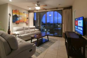 a living room with a couch and a flat screen tv at Stunning Oceanview Condo with Exceptional Views & Resort-Style Amenities in Coco