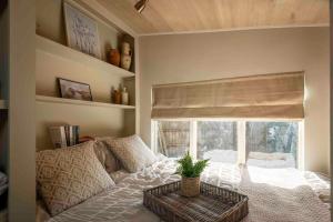 a bedroom with a bed and a window with a plant at The Nook Guest House in Letchworth