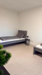 a white room with a bed and a table at Apartment Kist bei Würzburg in Kist +2 photos
