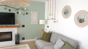 a living room with a couch and a tv at Villa Sueños in Mijas
