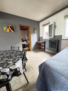 a bedroom with a bed and a fireplace at Patagonia y Deloqui in Ushuaia