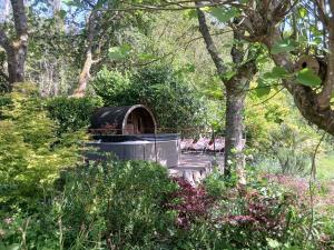 a gazebo in the middle of a garden at Le Temple Ysambre in Malansac
