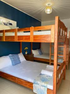 a bedroom with two bunk beds and a bed at Blue Water De Santorini in Puerto Galera