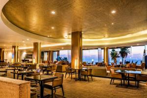 a lobby of a hotel with tables and chairs at חדר על הים בהרצליה in Herzliya B