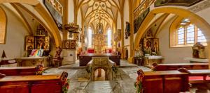 a large church with benches and a organ in it at Chalet Tauernbär in Großkirchheim