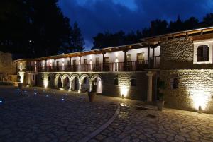 a building lit up at night with lights at Frontzu Politia in Ioannina