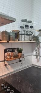 a kitchen with shelves with plants and pots on them at HuesPet&You in Sanlúcar de Guadiana