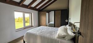 a bedroom with a large bed with a window at Quinta Cuadrao in Cartavio