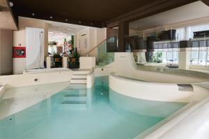 a bathroom with two sinks and a large mirror at Hotel Dante in Cattolica