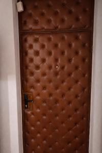 a brown door with a brown padded mattress at Apartman City With 3 Bedooms And Free Parking in Negotin