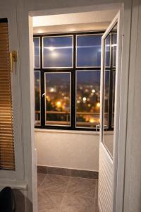 a room with a window with a view of a city at Apartman City With 3 Bedooms And Free Parking in Negotin