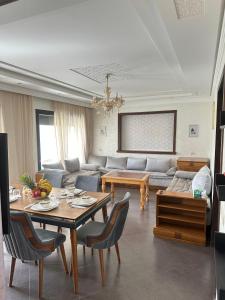 a living room with a couch and a table at Villa Aglou Center Near Mirlaft in Zaouia Sidi Ouaggag