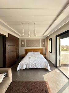 a bedroom with a large white bed in it at Villa Aglou Center Near Mirlaft in Zaouia Sidi Ouaggag +38 photos