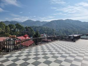 a balcony with a view of a mountain at Hotel Dalhousie Delight in Dalhousie