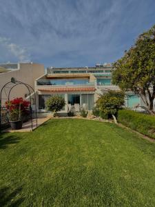 a large building with a lawn in front of it at Bayview Terraces Cozy 1BR Haven in Limassol
