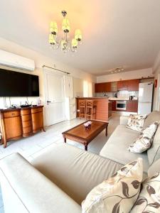 a living room with a couch and a table at Bayview Terraces Cozy 1BR Haven in Limassol