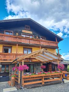 a large building with flowers in front of it at Penzion Havran in Ždiar