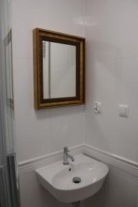a bathroom with a sink and a mirror on the wall at Agroturystyka u Oli in Smolany Dąb +40 photos