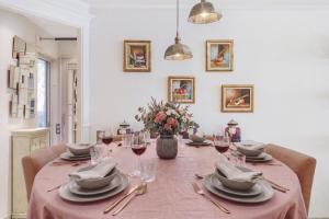 a dining room table with a pink table cloth at Appartement Centre de Saint-Tropez in Saint-Tropez