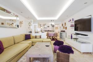 a living room with a couch and a table at Appartement Centre de Saint-Tropez in Saint-Tropez