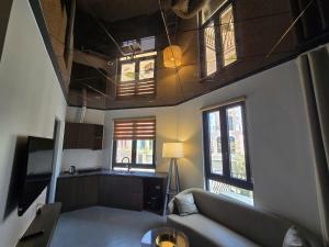 a living room with a couch and a kitchen at DOS GATOS Hotel in Ðố Sơn +8 photos