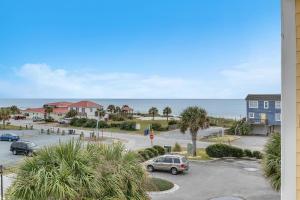 a view of a parking lot and the ocean at Mystic Shore in Oak Island