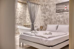 a bedroom with a bed with a bathtub and a bed at Staytopus St Elizabeth - Modern Apartment - in Xewkija