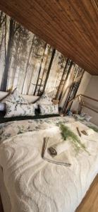 a bed with a blanket and pillows in front of a window at Green Home in Furth im Wald