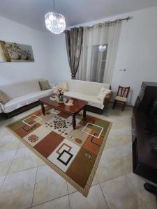 a living room with a couch and a coffee table at Krasaqua in Pogradec +1 photo